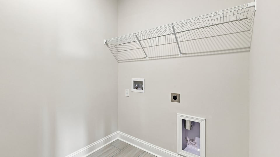 Laundry room with hanging storage racks.
