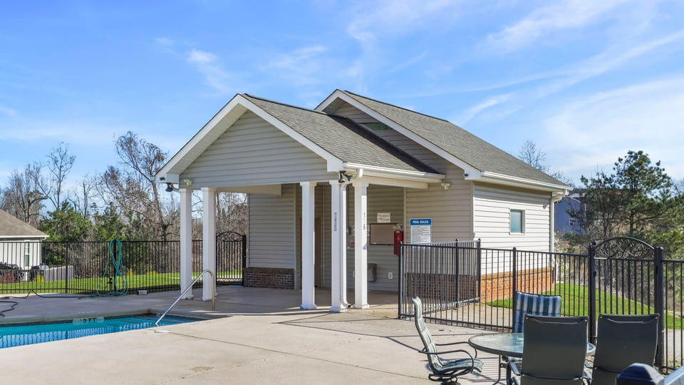 Pool area with clubhouse amenity.