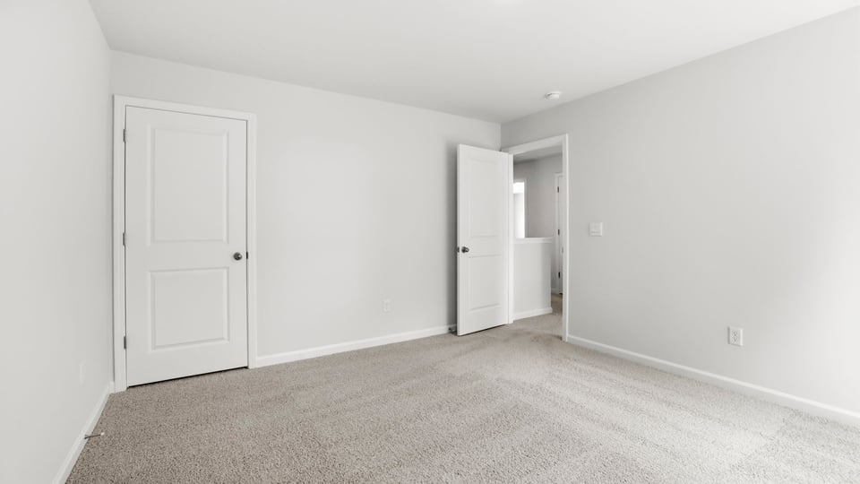 Bedroom with carpet and window.