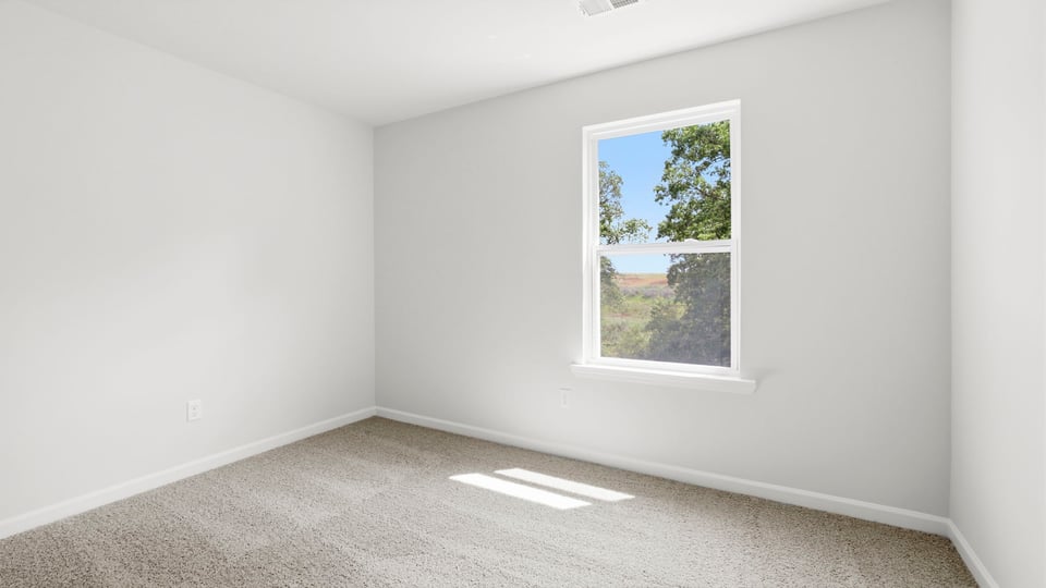 Bedroom with carpet and window.