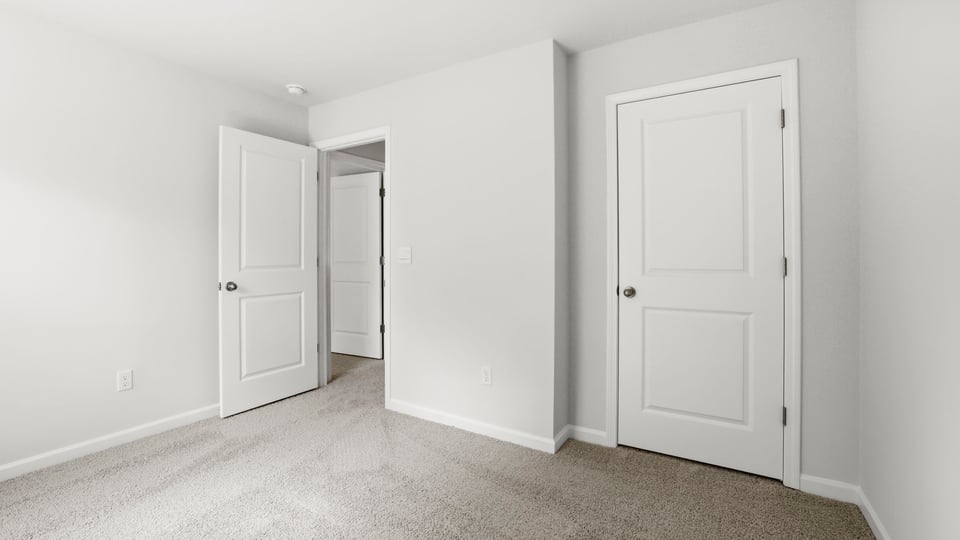 Bedroom with carpet and window.