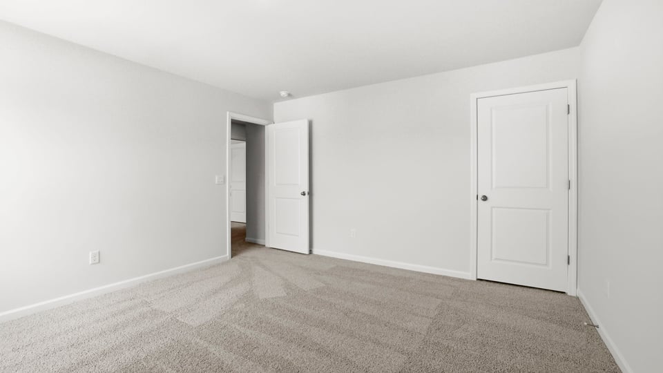 Bedroom with carpet and window.