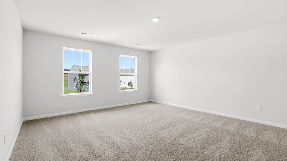 Bedroom with carpet and window.
