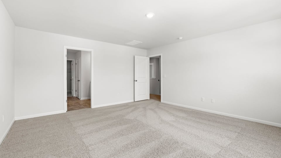 Bedroom with carpet and window.
