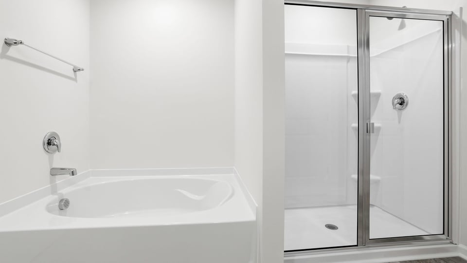 Bathroom with tub and walk in shower.