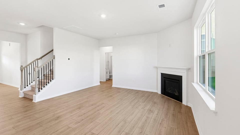 Living room with windows and fireplace.