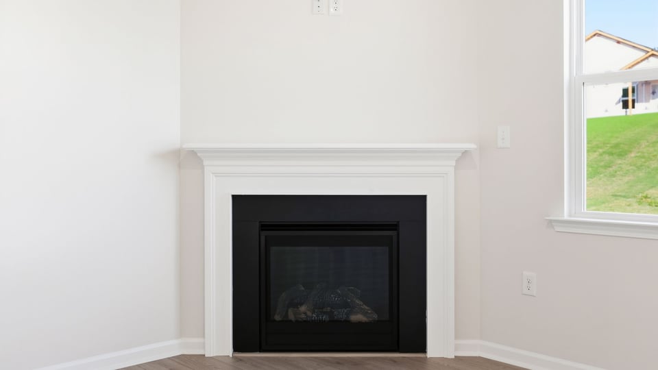 Living room with windows and fireplace.