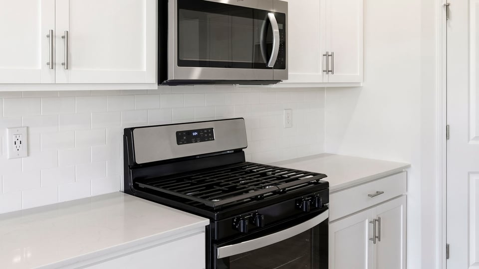 Kitchen and island with quartz countertops.