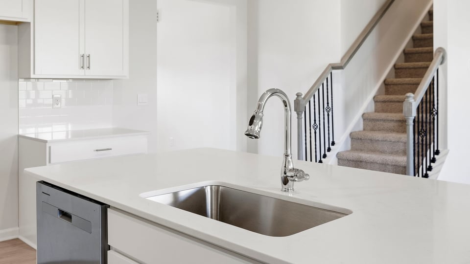 Kitchen and island with quartz countertops.
