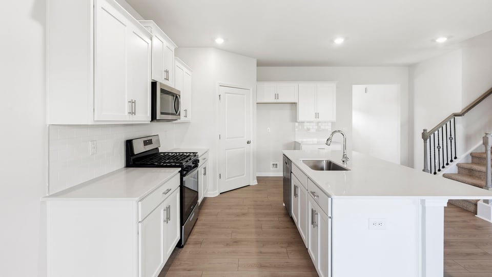 Kitchen and island with quartz countertops.