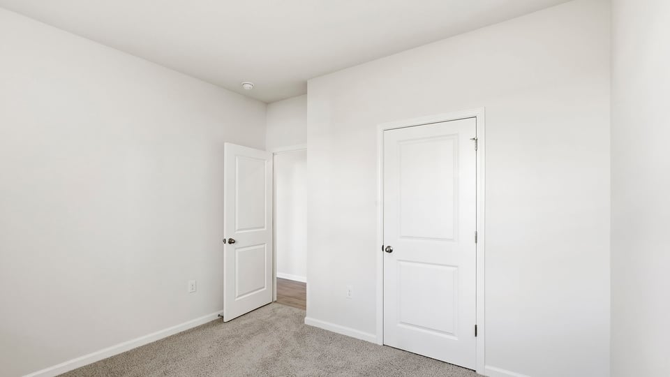 Bedroom with carpet and window.