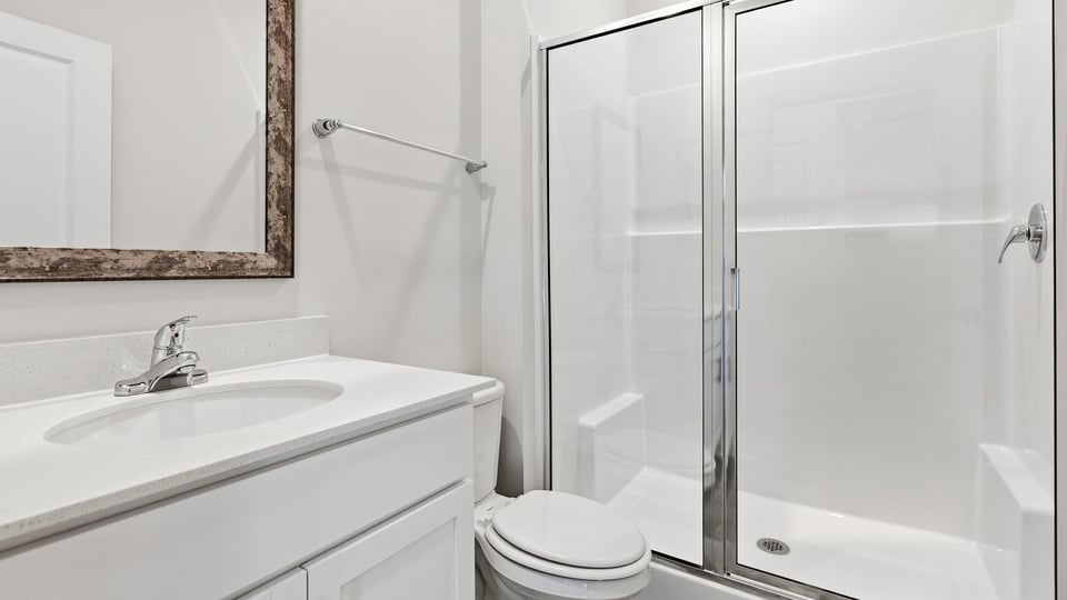 Bathroom with single vanity sink and walk in shower.