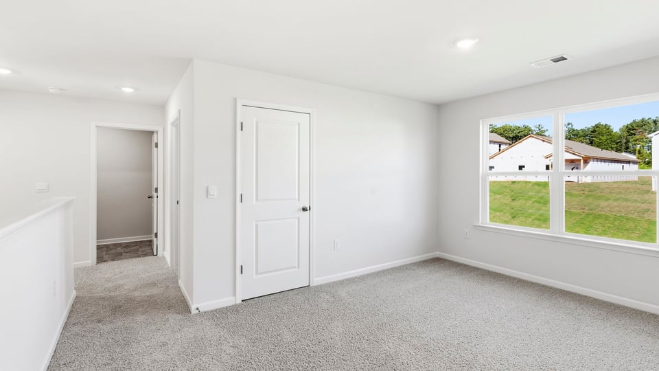 Bedroom with carpet and window.