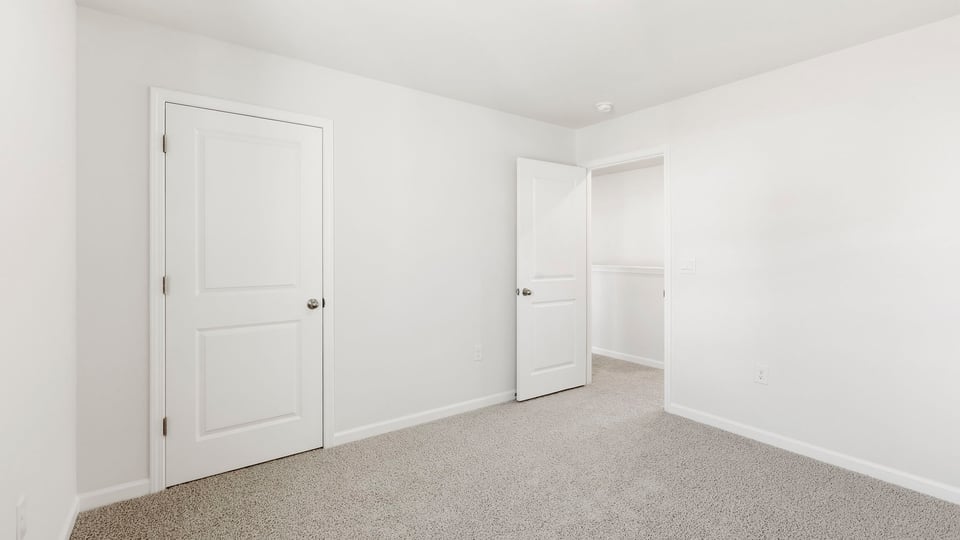 Bedroom with carpet and window.