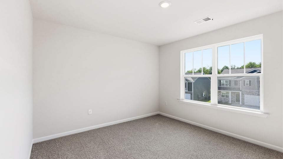 Bedroom with carpet and window.