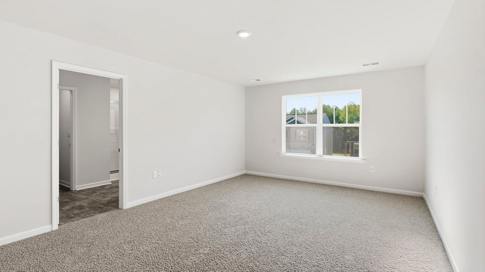 Bedroom with carpet and window.