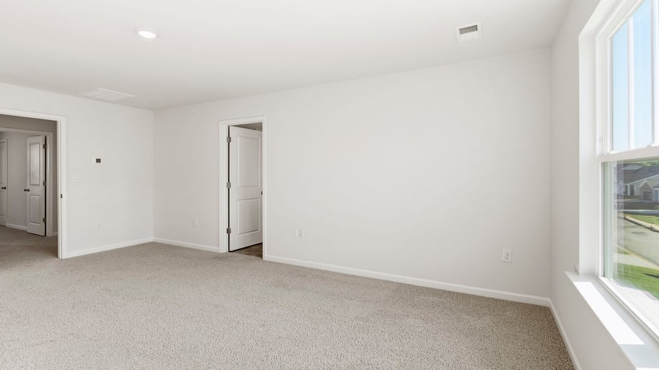 Bedroom with carpet and window.
