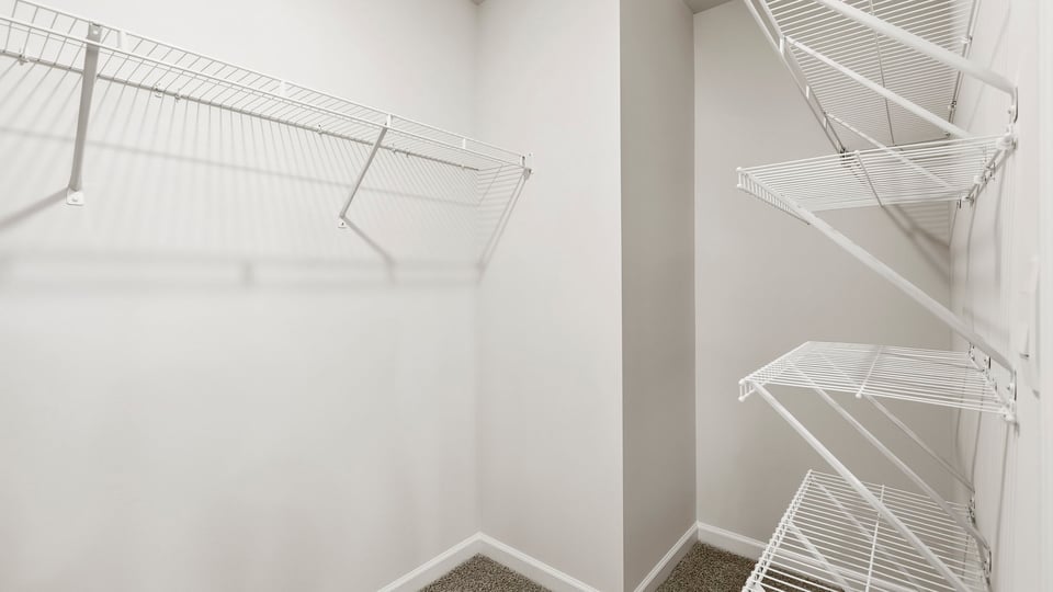 Closet with hanging storage racks.