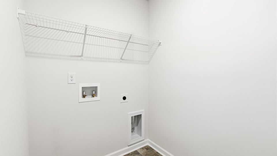 Laundry room with hanging storage racks.