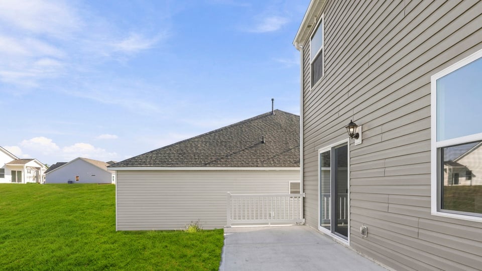 Back exterior of home with patio.