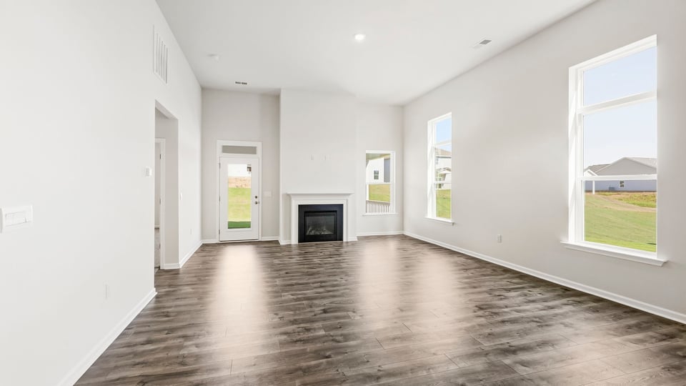 Living room with windows and fireplace.