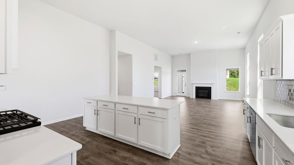 Kitchen and island with quartz countertops.