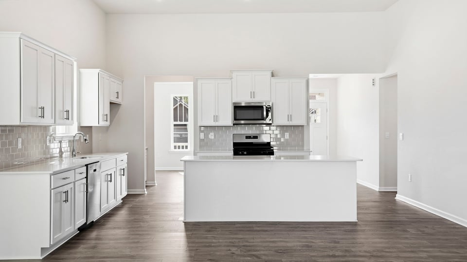 Kitchen and island with quartz countertops.