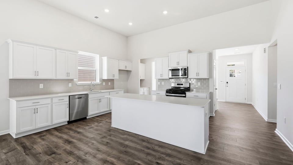 Kitchen and island with quartz countertops.