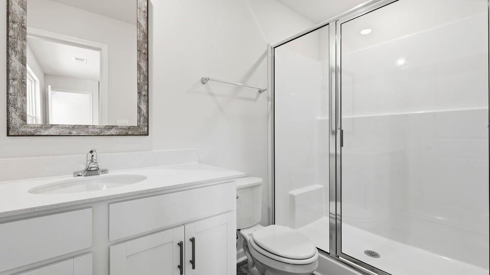 Bathroom with single vanity sink and walk in shower.