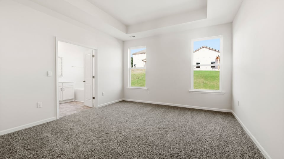 Bedroom with carpet and windows.