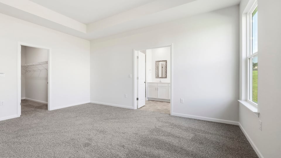 Bedroom with carpet and windows.