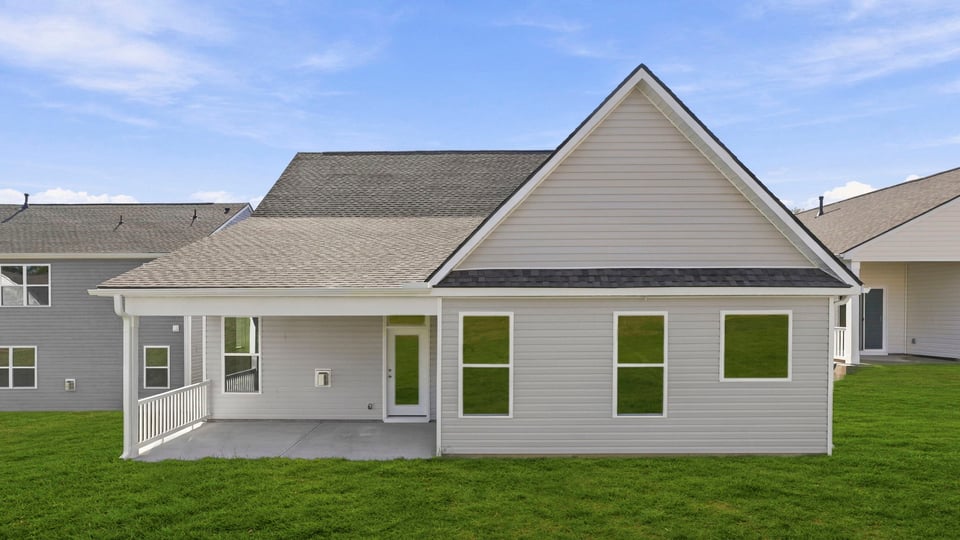 Back exterior of home with large backyard.