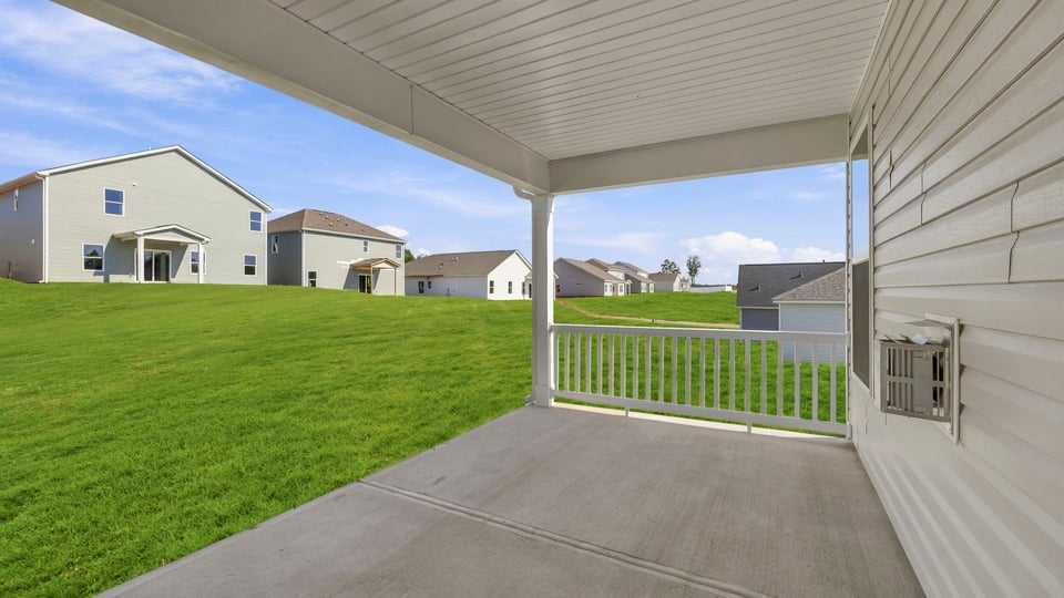 Back exterior of home with patio.