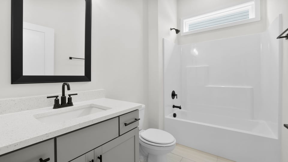 Bathroom with single vanity sink and bathtub.