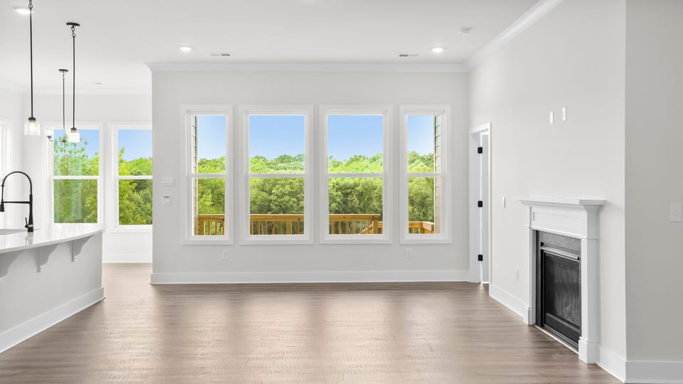 Living room with windows and fireplace.