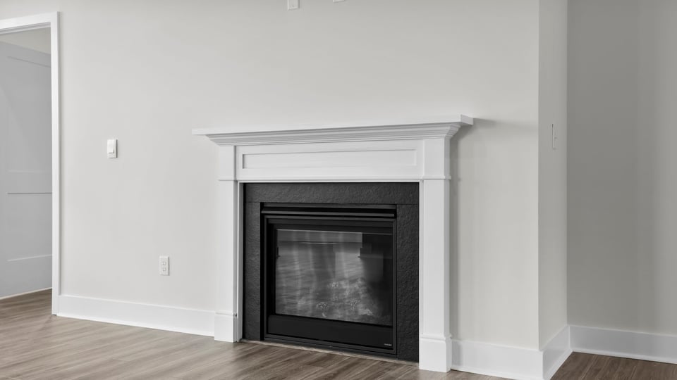 Living room with windows and fireplace.