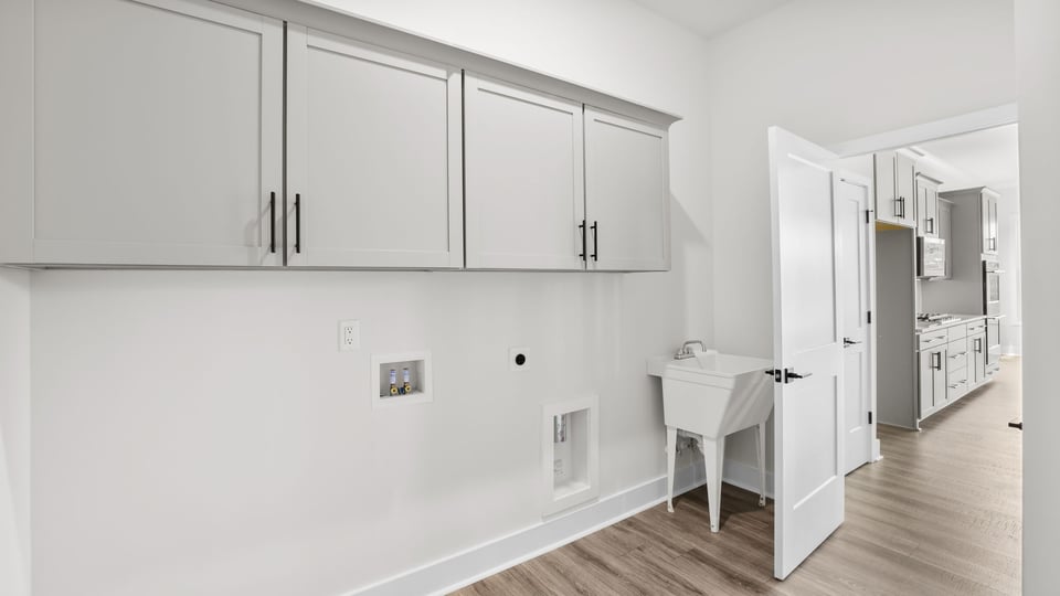 Laundry room with cabinets.