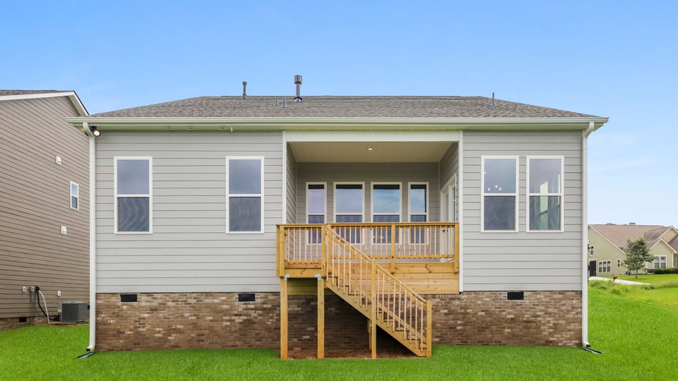 Back exterior of home with large backyard.