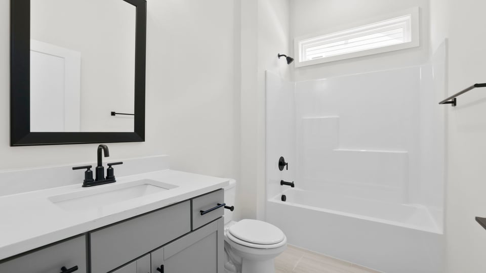 Bathroom with single vanity sink and bathtub.