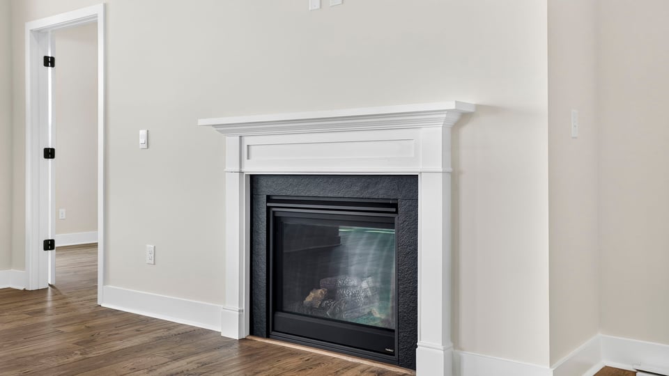 Living room with windows and fireplace.