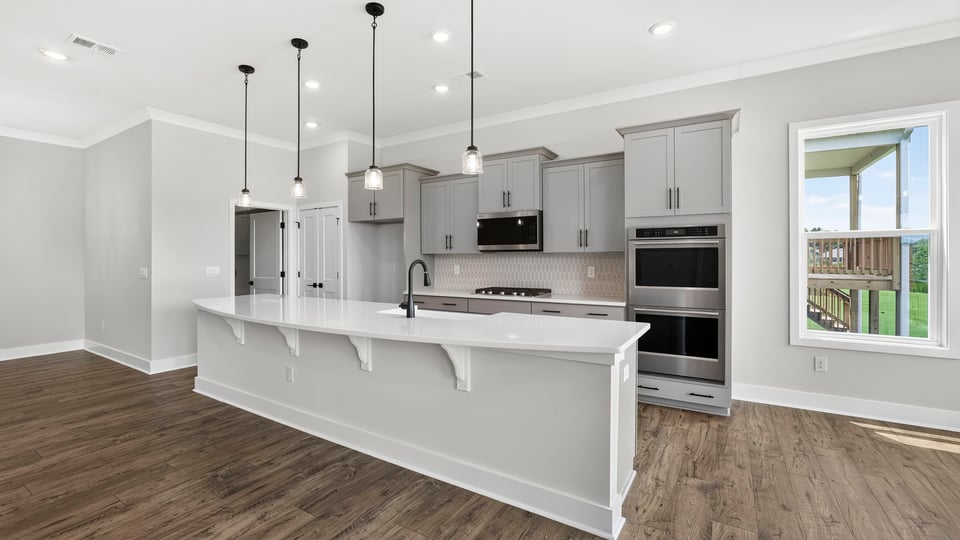 Kitchen and island with quartz countertops.