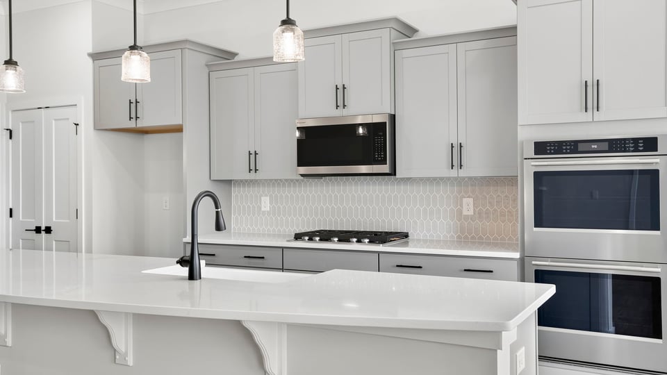 Kitchen and island with quartz countertops.