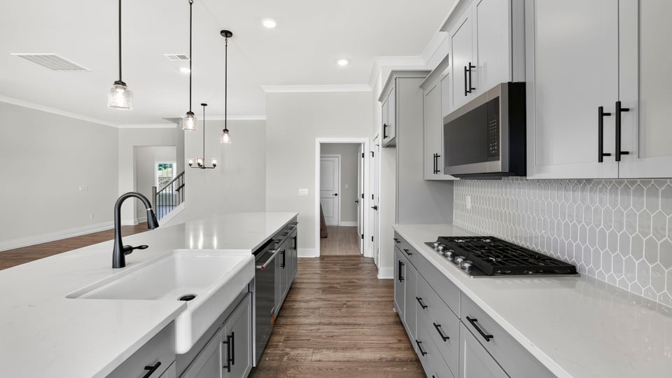 Kitchen and island with quartz countertops.