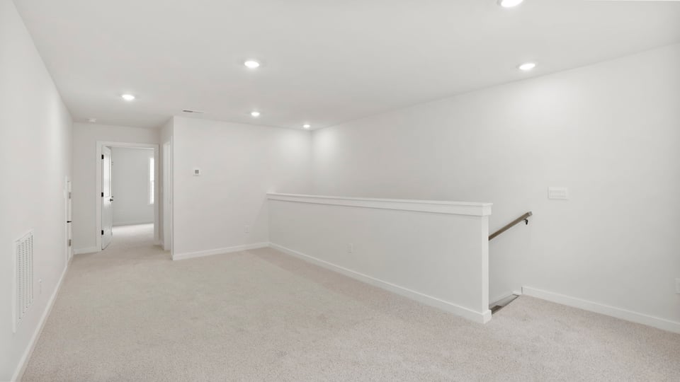 Loft area with carpet and window.