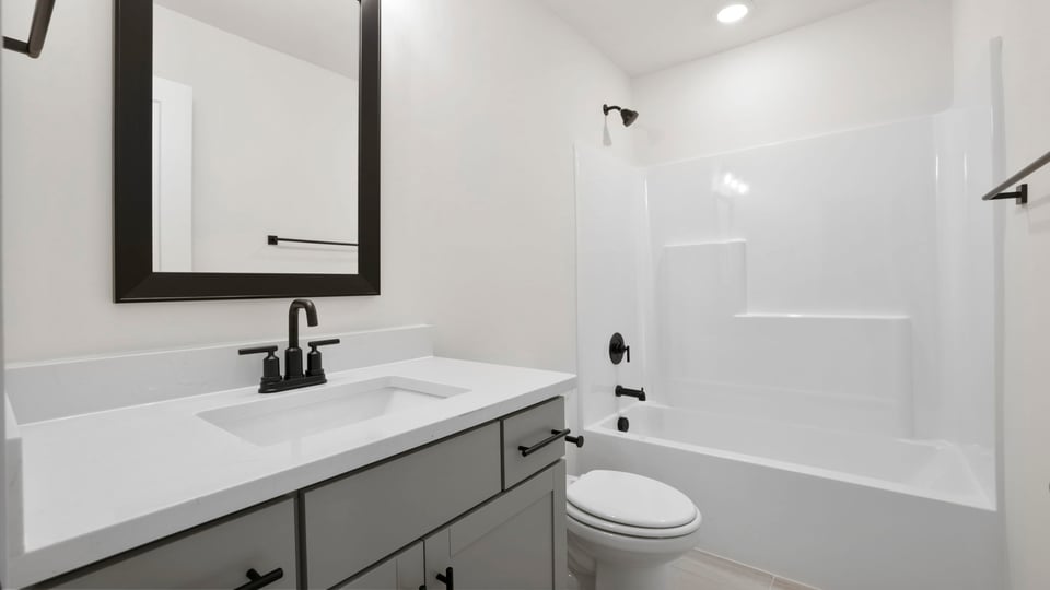 Bathroom with single vanity sink and bathtub.