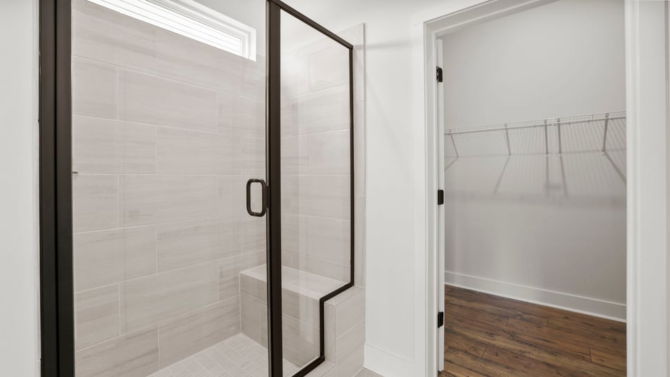Bathroom with walk in shower and closet.