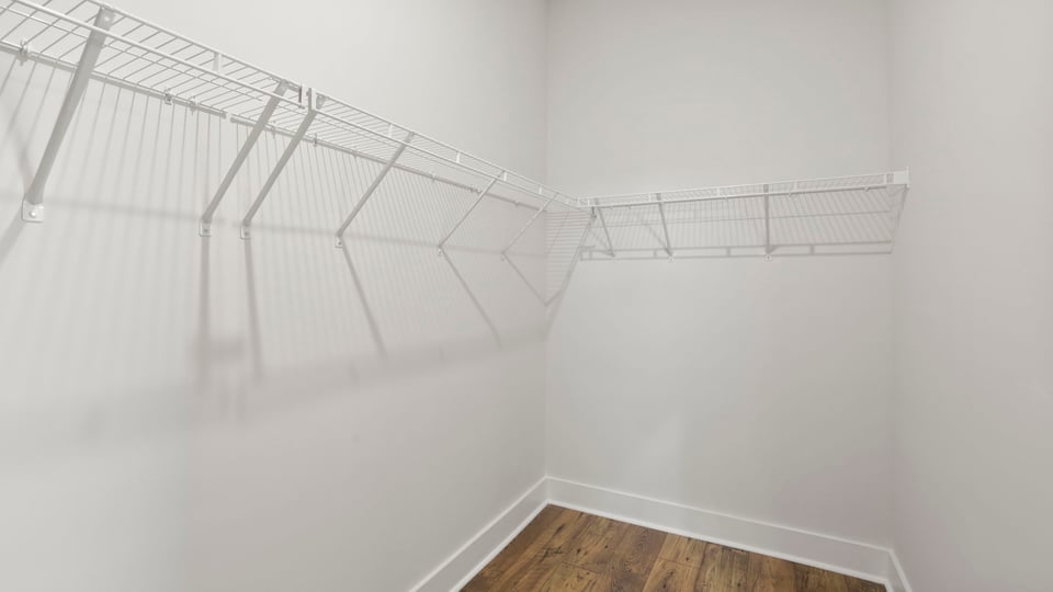 Closet with hanging storage racks.