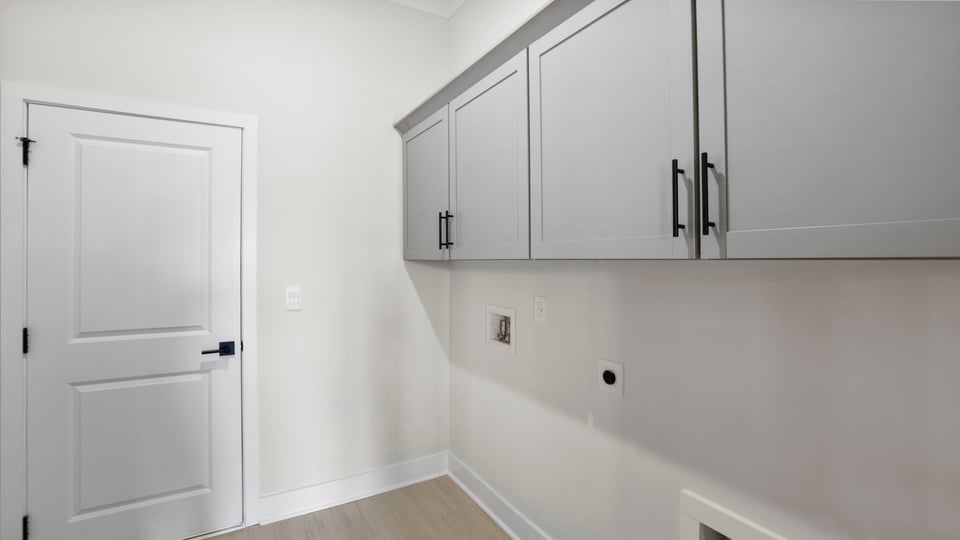 Laundry room with cabinets.