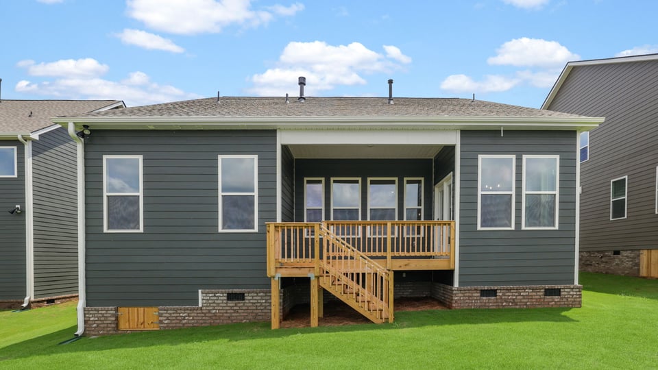 Back exterior of home with large backyard.