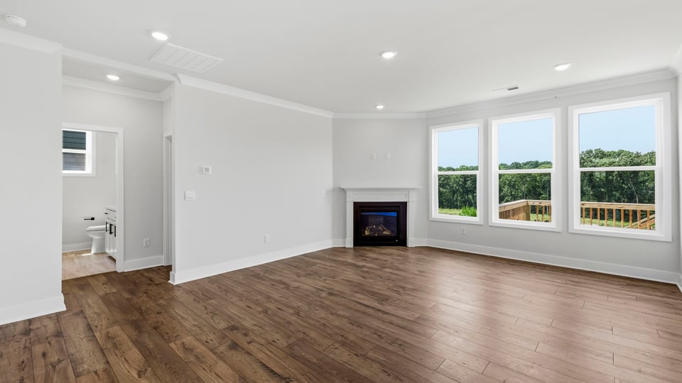 Family room with large windows and fireplace.